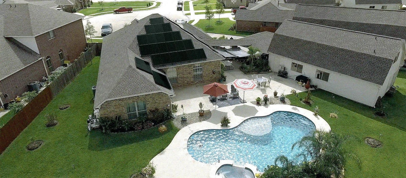 Home with solar panels and pool