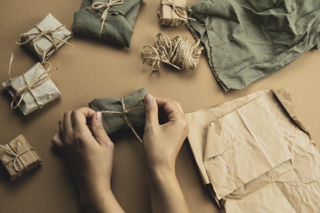 Female Hands wrapping eco-friendly gift